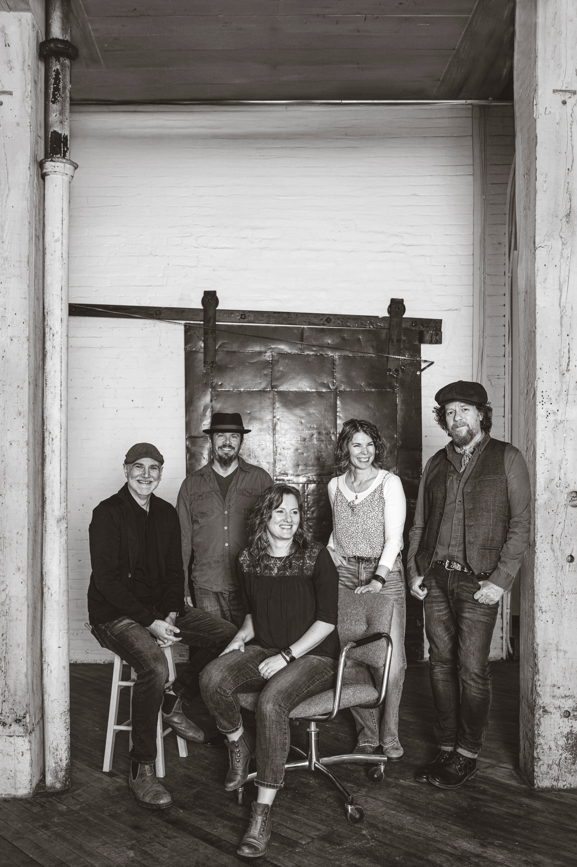 The Bookends in front of an old blast door in a converted factory setting